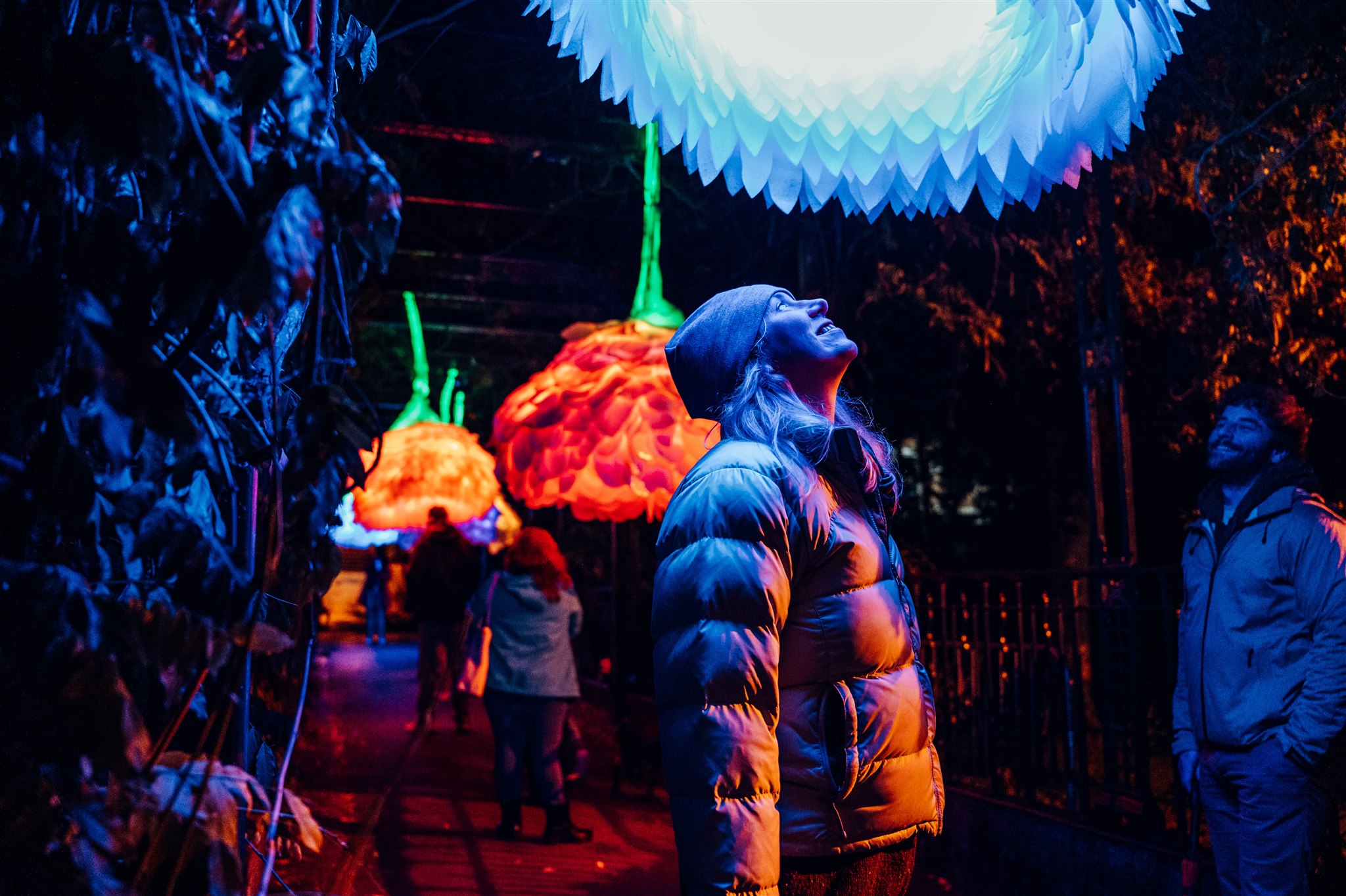 Woman looking up at light installation