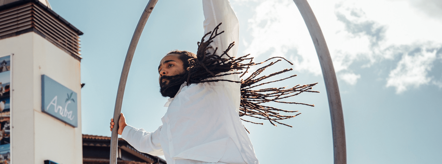 Man performing in a metal hula hoop ring