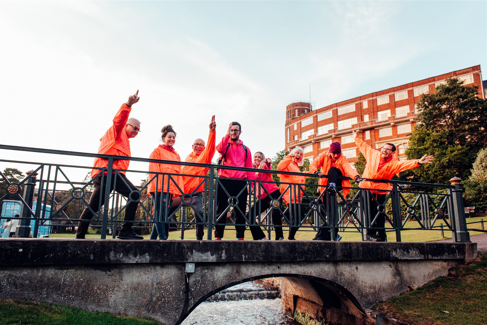 Group of volunteers dancing on a bridge